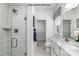 This modern bathroom features a glass enclosed shower, a white vanity, and a large mirror at 6037 Fonsac Ln # 2008A, Charlotte, NC 28217