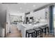 This bright kitchen features white cabinets, stainless steel appliances, and a large center island with stools at 6037 Fonsac Ln # 2008A, Charlotte, NC 28217