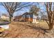 Back exterior view highlighting the elevated deck, brick facade, and spacious yard at 605 18Th Nw St, Hickory, NC 28601