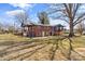 Expansive backyard featuring a two-story brick home with covered porch and a large tree at 605 18Th Nw St, Hickory, NC 28601
