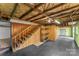 Unfinished basement with exposed ceiling, wood paneled walls, and stairs to the upper level at 605 18Th Nw St, Hickory, NC 28601