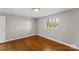 Simple bedroom features hardwood floors, natural lighting, and neutral paint at 605 18Th Nw St, Hickory, NC 28601