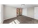 Carpeted bedroom featuring bright light through the windows and doors, as well as a closet at 605 18Th Nw St, Hickory, NC 28601