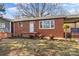 Well-maintained home with a red brick facade, covered porch, and manicured landscaping at 605 18Th Nw St, Hickory, NC 28601