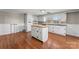 Bright kitchen with hardwood floors features all white cabinetry, a dark countertop and an island at 605 18Th Nw St, Hickory, NC 28601