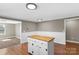 Spacious kitchen with hardwood floors features an island and a view into the carpeted living room at 605 18Th Nw St, Hickory, NC 28601