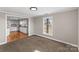 This carpeted living room looks into the kitchen and has a big bright window at 605 18Th Nw St, Hickory, NC 28601