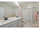 Bright bathroom featuring a double vanity with a black faucet, patterned floor and shower at 623 Plowshare Way, Clover, SC 29710
