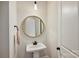 Elegant powder room features pedestal sink with gold-trimmed mirror and black fixtures at 623 Plowshare Way, Clover, SC 29710