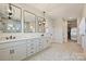 Stylish bathroom with a double vanity, rectangular mirrors, and a walk-in shower with elegant tile work at 623 Plowshare Way, Clover, SC 29710