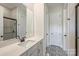 Stylish bathroom featuring patterned floors, quartz counters, and a modern glass-enclosed shower at 623 Plowshare Way, Clover, SC 29710