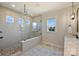 Elegant bathroom featuring a glass shower, marble counters, and bright windows at 623 Plowshare Way, Clover, SC 29710