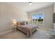 Serene bedroom with plush bedding, natural light, and a view of the outdoors at 623 Plowshare Way, Clover, SC 29710