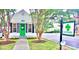 Quaint office building with a green door and mature trees, offering a welcoming atmosphere at 623 Plowshare Way, Clover, SC 29710