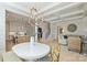 Elegant dining area with coffered ceilings, chandelier, and easy access to kitchen and living room at 623 Plowshare Way, Clover, SC 29710