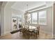 Bright dining area with large windows, modern chandelier, and access to the backyard at 623 Plowshare Way, Clover, SC 29710