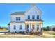 Charming white two-story home featuring a welcoming front porch and neatly landscaped yard at 623 Plowshare Way, Clover, SC 29710