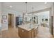 Open-concept kitchen with a large island, modern fixtures, and views into the living and dining areas at 623 Plowshare Way, Clover, SC 29710