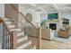 Cozy living room with a fireplace, hardwood floors, and comfortable seating near a staircase at 623 Plowshare Way, Clover, SC 29710