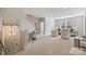 Spacious, carpeted living room with staircase, neutral furniture, and ample natural light at 623 Plowshare Way, Clover, SC 29710