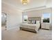 Serene main bedroom with tray ceilings, plush carpet, and two bright windows at 623 Plowshare Way, Clover, SC 29710