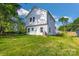 Backyard view of a two-story white home with a large grassy area at 695 S Elm St, Statesville, NC 28677