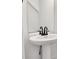 Bright bathroom featuring a white pedestal sink with modern black fixtures and a large mirror at 695 S Elm St, Statesville, NC 28677
