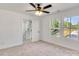 Bright bedroom with carpet, ceiling fan, and windows offering scenic neighborhood views at 695 S Elm St, Statesville, NC 28677