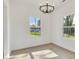 Bright dining room featuring wood-look flooring, contemporary chandelier, and large window at 695 S Elm St, Statesville, NC 28677