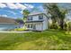 View of the side and backyard of a two-story home with green lawn at 695 S Elm St, Statesville, NC 28677