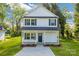 Charming two-story home featuring a covered porch and freshly landscaped yard at 695 S Elm St, Statesville, NC 28677