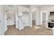 Open kitchen featuring modern white cabinets, stainless appliances, and wood-look flooring at 695 S Elm St, Statesville, NC 28677
