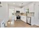 Bright kitchen with white cabinets, stainless steel appliances, and wood-look flooring at 695 S Elm St, Statesville, NC 28677