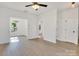 Open-concept living space with wood-look flooring, modern lighting, and ample natural light at 695 S Elm St, Statesville, NC 28677