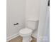 Clean, white toilet in a minimalist bathroom featuring modern fixtures and light wood flooring at 695 S Elm St, Statesville, NC 28677
