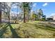 A backyard with lake access with a dock, gazebo, and green space at 7201 Cedarfield Rd, Charlotte, NC 28227