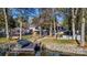 Large backyard with a deck, gazebo, and a view of the lake and a personal boat dock at 7201 Cedarfield Rd, Charlotte, NC 28227