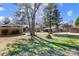 Large, level backyard with mature trees, and a view of outbuildings at 7201 Cedarfield Rd, Charlotte, NC 28227