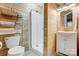 Rustic bathroom featuring wood paneling, a glass-enclosed shower, and modern fixtures for a cozy feel at 7201 Cedarfield Rd, Charlotte, NC 28227