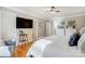 Comfortable bedroom with hardwood floors, a ceiling fan, and a large wall-mounted television at 7201 Cedarfield Rd, Charlotte, NC 28227
