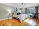 Sunlit bedroom with hardwood floors, a queen bed, and stylish decor offers a tranquil retreat at 7201 Cedarfield Rd, Charlotte, NC 28227