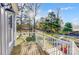 A bright deck overlooking a lush yard and lake with ample space for seating at 7201 Cedarfield Rd, Charlotte, NC 28227