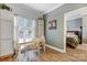 Bright dining area with a wooden table and chairs, adjacent to a bedroom, creating a welcoming space at 7201 Cedarfield Rd, Charlotte, NC 28227