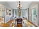 Bright dining room with a large table, hardwood floors, and natural light from the windows at 7201 Cedarfield Rd, Charlotte, NC 28227