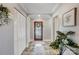 Inviting entryway featuring tile floors, closet space, stylish decorations, and glass-paneled front door at 7201 Cedarfield Rd, Charlotte, NC 28227