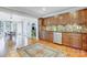 Updated kitchen boasting stainless appliances, wooden cabinets, and stylish backsplash at 7201 Cedarfield Rd, Charlotte, NC 28227