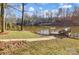 Lakeside view with a private dock and lush landscaping surrounding the waterfront at 7201 Cedarfield Rd, Charlotte, NC 28227