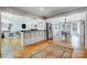 Open layout with a kitchen, living, and dining area with hardwood floors and natural light at 7201 Cedarfield Rd, Charlotte, NC 28227