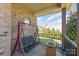 Cozy back porch with swing and outdoor fireplace, perfect for relaxation at 8137 Caliterra Dr, Charlotte, NC 28227