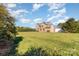 Exterior shot of the brick house with a large grassy backyard at 8137 Caliterra Dr, Charlotte, NC 28227